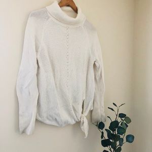 Classic white turtleneck with tie detailing